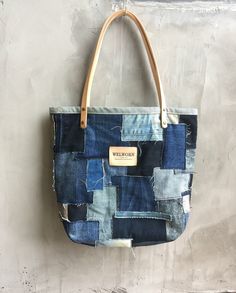 a blue patchwork bag hanging on a wall