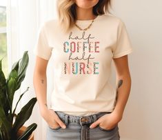 a woman standing next to a potted plant wearing a t - shirt