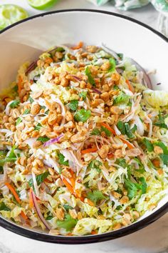 a white bowl filled with coleslaw and nuts