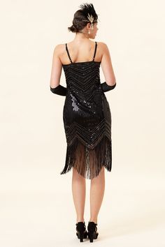 the back of a woman in a black flap dress