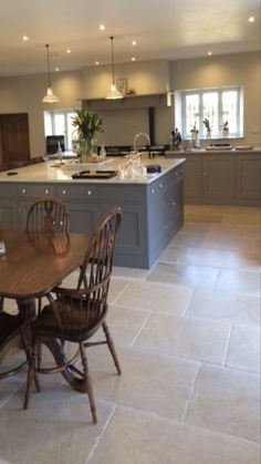 a kitchen with a table and chairs in it