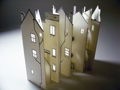 three paper houses sitting on top of each other