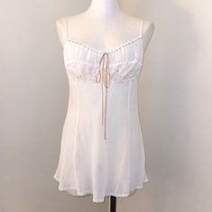 Rare And Iconic Item Alert!! This Highly Sought After Victoria's Secret *Almost Vintage* Y2k Milkmaid Babydoll Style 100% Silk Piece Is What My Lingerie Dreams Are Made Of Not Bright Stark White, More Of A Soft Ivory Color, With Dusty Rose Pink Details Ribbon At The Top Of The Bust Area Is Adjustable Lace, Beads, And Sequins Complete The Y2k Kawaii Fairy Look Low Cut Open Back With An Adjustable Bra-Like Closure. Straps Are Also Adjustable The Silk Has Some Texture To It As You Can See. Gently Worn And Overall Very Good Preloved Condition Size Large. Irl Colors May Vary Slightly From Photos This Same Style (Different Colorway) Was Popularized By Paris Hilton In The E Fitted White Victoria's Secret Sleepwear, Fitted Feminine White Nightgown, White Fitted Feminine Nightgown, White Coquette Nightgown For Spring, Coquette White Nightgown For Spring, White Fitted Feminine Sleepwear, White Feminine Fitted Sleepwear, Fitted White Feminine Sleepwear, White Coquette Sleepwear For Summer