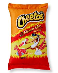 a bag of cheetos sitting on top of a pillow