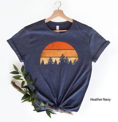 "Camping Gift Shirt, Forest Themed Shirt, Tree Shirt, Adventure Is Calling, Sunset Themed Shirt, Wildlife Tee, Wilderness, Pine Tree Thank you for shopping with us❤️ Size - Our products are unisex fit - You can check our size and color charts on our listing photos. How To Order - Select a size - Select a t-shirt color - If available, indicate the design (text) color in the personalization box - Click add to cart. You can go back to add more shirts. - Click \"Proceed to check out\". Care Instruct Forest Camping, Adventure Is Calling, Retro Camping, Camping Tee, Retro Sun, Chicken Shirts, Gifts For Campers, Vintage Camping, Tree Shirt