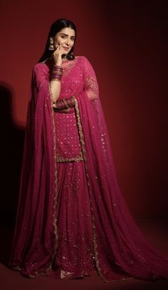 a woman in a pink lehenga