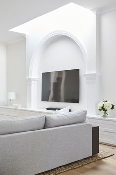 a large flat screen tv mounted to the side of a wall in a living room