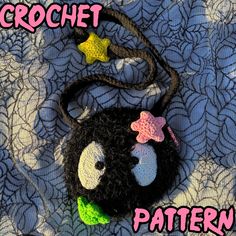 a crochet bag with a face and stars on it