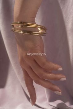 Gold Plated bangles, Set of 5 bangles Brass bangles Stackable bangles Minimalist bangles Boho bangles Simple Bangles 5 Day bangles For Woman Handmade item Materials: Brass Adjustable : No Style: Bangles Bracelet Bracelet Size Inches Circumference/Diameter 7 / 2.23 7.5 / 2.39 8 / 2.55 8.5 / 2.71 9 / 2.87 9.5 / 3 Elegant, , minimal and shiny ! A lovely basic to have in your wardrobe and wear anytime  O T H E R ∙ I N F O R M A T I O N * All items are nicely packaged ready to gift in elegant jewelry Cheap Hand-strung Bangle, Adjustable Trendy Bangle At Affordable Price, Simple Bangles, Boho Bangles, Minimalist Bangle, Boho Bangle, Simple Bangle, Stackable Bangles, Bangles Set