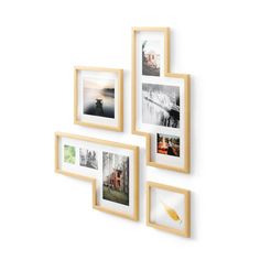 three wooden frames are hanging on the wall with multiple pictures in them and one is empty