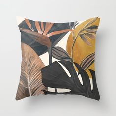 a pillow with tropical leaves on it