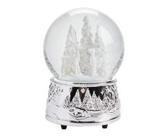 a snow globe with trees and mountains in it