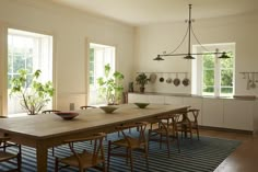 a dining room table with chairs and bowls on it