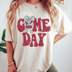 New product- Vintage Alabama Crimson Tide Game Day Shirt! Get ready to show off your Roll Tide pride with our Vintage Alabama Shirt, a must-have for all fans! This unique design combines a vintage style with the fierce spirit of Crimson Tide, creating a shirt that stands out from the crowd. Each shirt is meticulously printed by me using high-quality materials on a Comfort Colors shirt, known for its exceptional comfort and durability. Whether you're cheering on the crimson tide at the stadium or simply want to showcase your school spirit in your everyday attire, this shirt is the perfect choice. Available in sizes S to 3X, we've got you covered regardless of your preferred fit. This Game Day Shirt features a classic crew neck and short sleeves, making it suitable for year-round wear. The f Alabama Shirt Ideas, Alabama Football Shirts, Alabama Game Day, Game Day Tshirt, Alabama Shirt, Alabama Shirts, Htv Shirts, School Designs, School Spirit Shirts