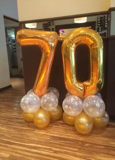 an image of balloons in the shape of numbers on wood flooring and table top