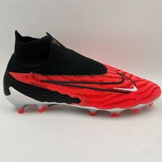 a pair of black and red nike soccer cleats