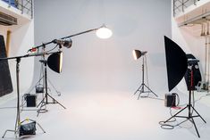 three photography lighting equipment set up in a studio