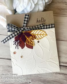 a close up of a card with flowers in the background