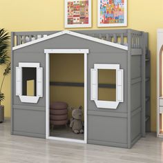 a child's bedroom with a lofted bed and gray play house for the dollhouse