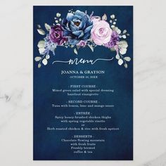 a wedding menu card with flowers on it