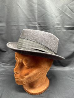 Vintage 1950's Emerson of Fifth Ave Charcoal Grey Wool Fedora Est. Size 7 Add a touch of vintage style to your wardrobe with this charcoal grey wool fedora from Emerson of Fifth Ave. The classic design is perfect for any occasion and the 100% wool material ensures durability and comfort. This fedora is estimated to be a size 7 and is a great addition to any collection. The brand is known for their quality and this piece is no exception. Perfect for the fashion-forward individual who appreciates timeless style. Vintage Fitted Felt Hat For Fall, Retro Winter Fedora With Flat Brim, Retro Flat Brim Fedora For Winter, Winter Wool Hat Bands, Fitted Wool Hat Bands For Winter, Wool Hat Bands For Winter, Vintage Fitted Hat Bands For Fall, Gray Fitted Felt Hat For Winter, Gray Felt Hat For Winter