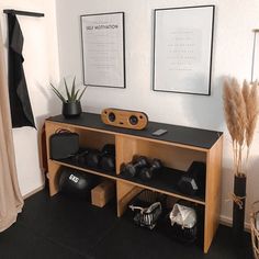 there is a shelf with some items on it in the room next to two pictures