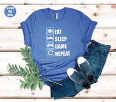 🎮 Hello there gamer!! 🎮 🏆 Are you ready to upgrade your wardrobe to the next level?!! 🏆 Check out our adorable and quirky Gaming T-Shirt. This delightful tee features a playful of "Eat Sleep Game Repeat" and it's a must have! 🔸100% combed and ring-spun cotton (Heather colors contain polyester 1-10%) 🔸Lightweight (4.2 oz/yd² or 142 g/m²) 🔸Tear-Away Label 🔸Ribbed knit collars and shoulder-to-shoulder taping 🧽Machine wash: cold (max 30C or 90F); Non-chlorine: bleach as needed; Tumble dry: Casual Tops With Letter Print For Gaming Events, Casual Letter Print Top For Gaming Events, Casual Top With Letter Print For Gaming Events, Casual Short Sleeve T-shirt For Gaming Events, Gamer Tops With Letter Print, Cotton T-shirt With Letter Print For Gaming Events, Eat Sleep Game Repeat, Gaming Tees, Funny Gaming