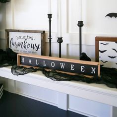 a shelf with halloween decorations and candles on it