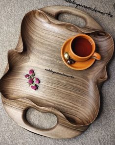 a wooden tray with a cup and saucer on it