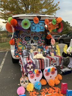 a car with decorations on the back and an assortment of items in front of it