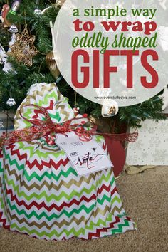 a christmas tree with presents under it and the words, a simple way to wrap old - shaped gifts