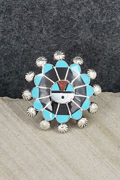 This Zuni Sunface set featuring turquoise, onyx, mother of pearl, coral, opalite and sterling silver inlay necklace, earrings, ring and bracelet was made by Zuni silversmith Abel Soseeah. The set is signed.Necklace: 18"Pendant Length: 2 5/8"Pendant Width: 1 3/4"Earrings:Length: 2 3/4"Width: 1 1/4"Bracelet:Size: 5 5/8" (will fit up to a 6 5/8" wrist)Gap: 1"Width: 1 5/8"Ring:Size 7.5Width: 1 1/4Length: 1 1/4Free shipping on all orders! We ship with USPS and always include tracking. All orders ship Sterling Silver Turquoise Inlay Jewelry, Turquoise Inlay Sterling Silver Jewelry, Sterling Silver Artisan Jewelry With Inlay, Artisan Sterling Silver Jewelry With Inlay, Artisan Sterling Silver Inlay Jewelry, Unique Adjustable Jewelry With Inlay, Southwestern Silver Jewelry With Inlay, Adjustable Artisan Jewelry With Inlay, Turquoise Spiritual Jewelry With Inlay