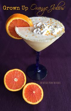 an orange margarita garnished with whipped cream and served in a coupe glass on a purple tablecloth