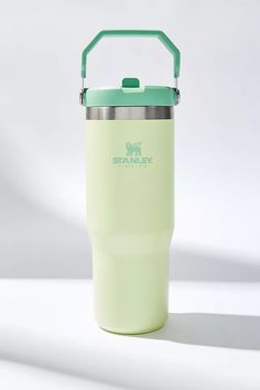 a light green insulated cup with a handle