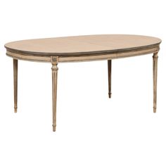 an oval dining table with two leaves on the top and one leaf at the bottom