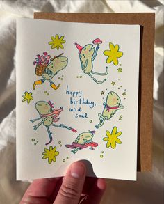 a hand holding up a birthday card that says happy birthday and two mice on it