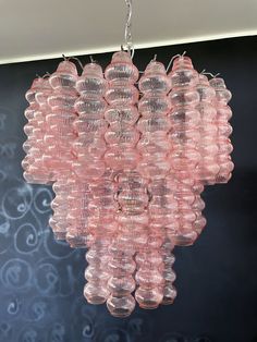 a pink chandelier hanging from a ceiling