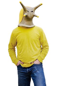 a man wearing a yellow shirt with an animal mask on his head