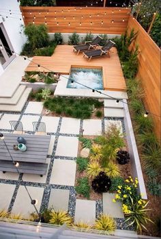 an aerial view of a small backyard garden with seating and hot tub in the center