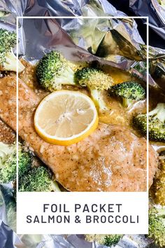 foil packet with salmon and broccoli on it next to a lemon wedge in the middle