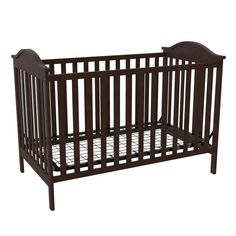 a baby crib that is brown and has no sheets on it, with the bottom rail