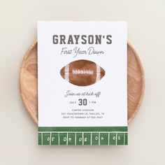 a football themed birthday party card on a wooden plate