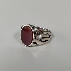 This sturdy signet-style ring features a braided knot band set in the center with a large polished red- orange carnelian agate cabochon. The top and bottom of the stone setting are embossed with an oxidized Greek key design. Sterling silver. Available in whole sizes 9-11. 1/2" at widest point. Also available in lapis here! Carnelian Agate, Orange Carnelian, Agate Cabochon, Stone Setting, Key Design, Greek Key, Onyx Ring, Signet Ring, Stone Settings