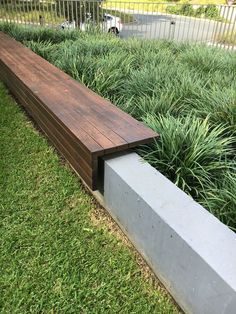 a wooden bench sitting on top of a lush green field