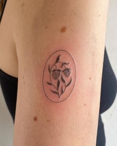 a woman's arm with a tattoo on it that has flowers in the center