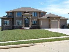 a large house with lots of windows and grass