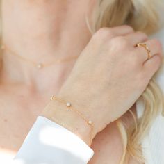 a close up of a person wearing a gold bracelet