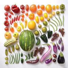 an array of different fruits and vegetables arranged in the shape of a rectangle on a white surface