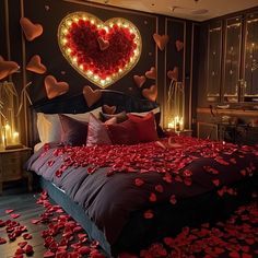 a bed with lots of red petals on it and a heart above the headboard