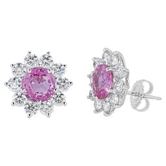 Stud earrings contain 2 finely matched round brilliant cut pink sapphires, 5.08tcw.. Surrounding pink sapphires are round brilliant diamonds creating a halo, totaling 3.08tcw. Diamonds are near colorless and VS2 in clarity, excellent cut. Stones are mounted in a handmade 18K prong setting with a pushback post closure. Total earring measure approximately 16x16mm in total. All of our pieces are packaged carefully and accompanied by a Pico box to keep your jewelry item safe. A complimentary apprais Luxury Pink Diamond Earrings Brilliant Cut, Luxury Pink Brilliant Cut Diamond Earrings, Luxury Pink Diamond Earrings With Accents, Luxury Pink Earrings With Brilliant Cut, Formal Pink Diamond Earrings, Luxury Pink Sapphire Earrings, Pink Diamond Jewelry With Halo Design, Pink Diamond Halo Jewelry, Pink Sapphire Jewelry With Halo Design